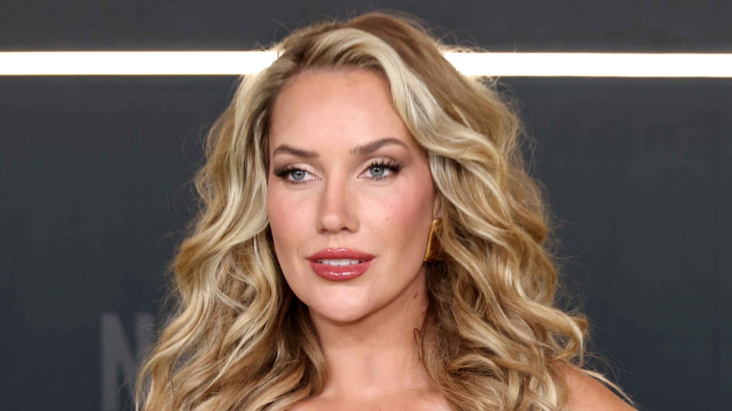 Paige Spiranac Tees Off in a Navy Halter Top and White Mini Skirt